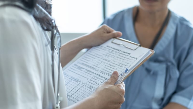 Patient health insurance claim form in doctor hands