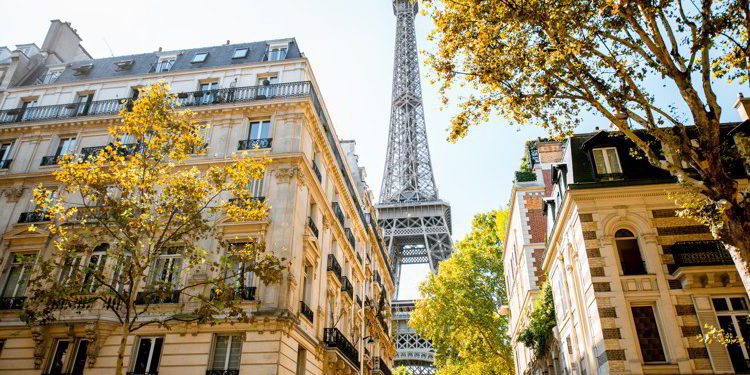 Beautiful street view with old residential buildings and Eiffel tower during the daylight in Paris