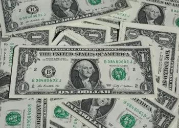a messy pile of dollar bills
