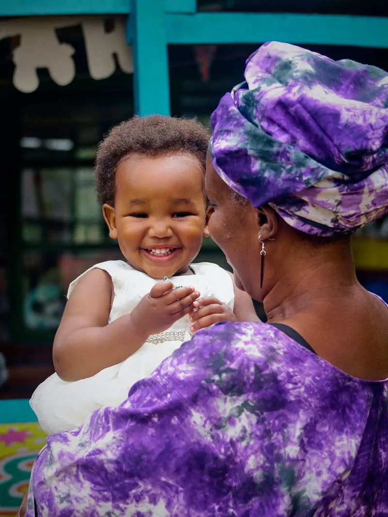 A girl smiling with her mother in Belize