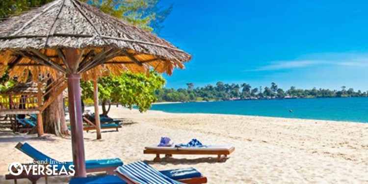 blue lounge chairs with umbrellas on the beach