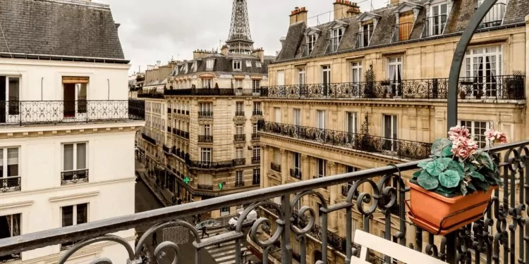 view of Paris apartment buildings from a balcony with a flowers