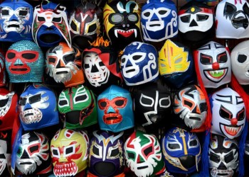colorful mexican wreslter masks hanging on a wall