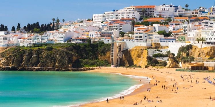 Portugal beach with yellow sand and blue seas during the summer