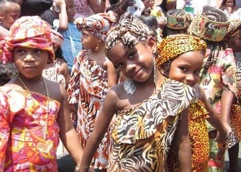 A group of young girls in African clothing in a parade
