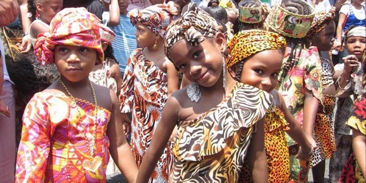 A group of young girls in African clothing in a parade