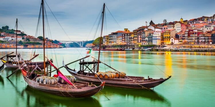 Sailboats with barrel cargo sitting in the harbour on the river in Lisbon, Portugal