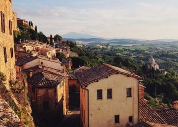 An aerial view of a rustic Italian town overlooking the countryside
