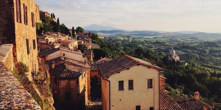 An aerial view of a rustic Italian town overlooking the countryside