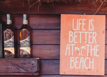 beach bar sign next to bottles. business ideas belize