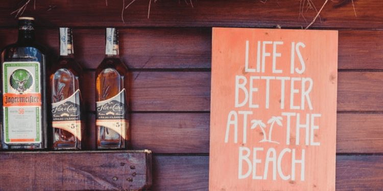beach bar sign next to bottles. business ideas belize