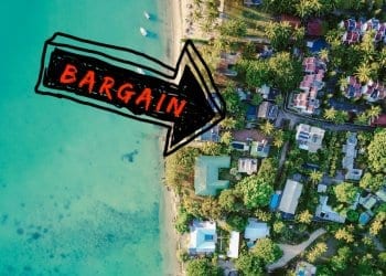 An aerial view down at homes along the beach with an arrow pointing to bargain properties.