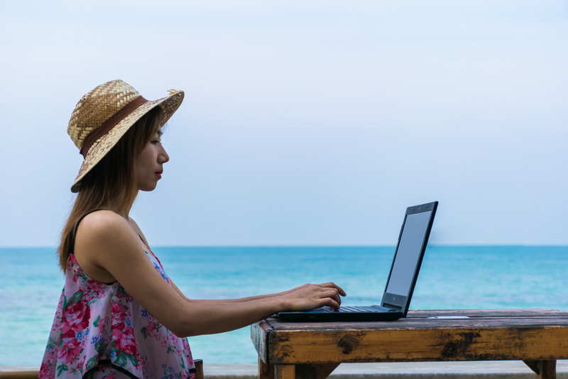 digital nomad working at the beach