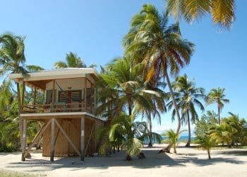 a beach side house in belize on stilts