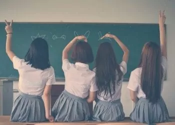 Kids in school sitting i n front of a blackboard