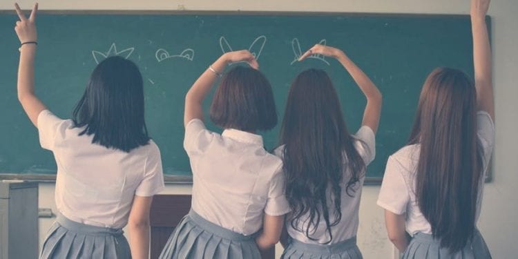 Kids in school sitting i n front of a blackboard