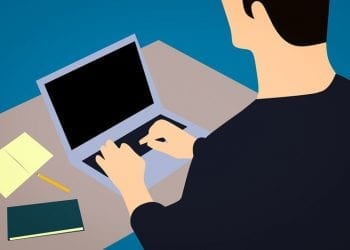 Cartoon image of a man working at a laptop. Best countries for digital nomads.