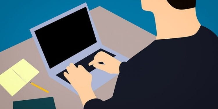Cartoon image of a man working at a laptop. Best countries for digital nomads.