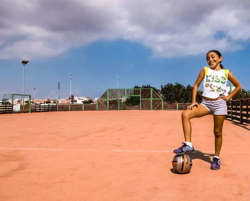 girl playing football in belize