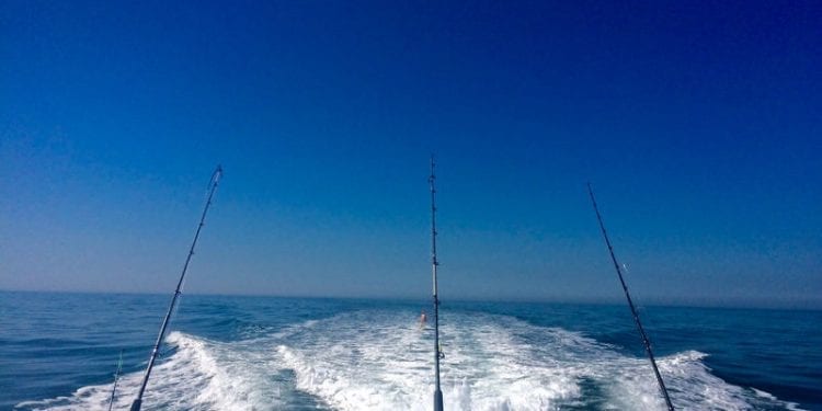 Offshore fishing boat with three rods