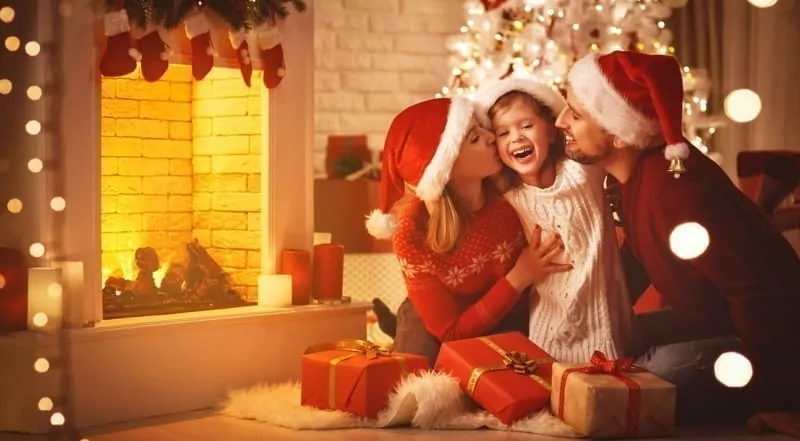 Happy family mother father and child celebrate Christmas