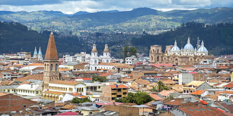 View of the city of Cuenca, Ecuador, with its many churches and rooftops, on a cloudy day
