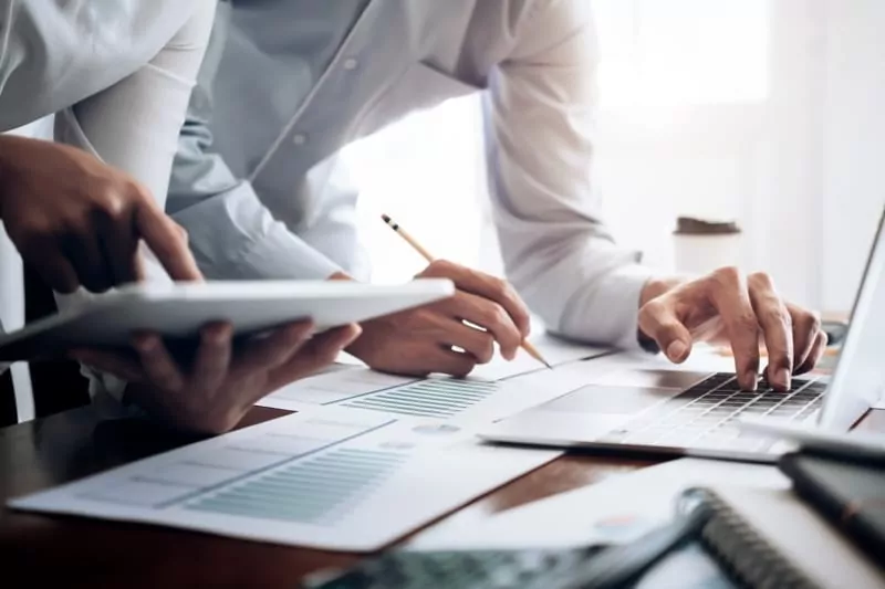 Two people working to diversify their assets offshore.