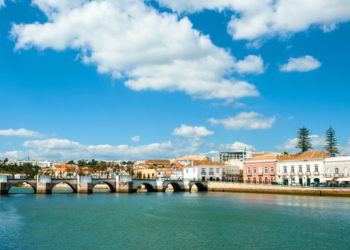 A bridge and colorful houses in Tavira town in Portugal