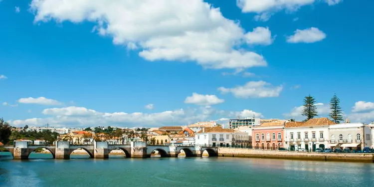A bridge and colorful houses in Tavira town in Portugal