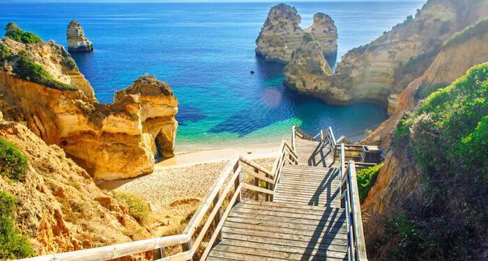 Wooden footbridge to beautiful beach Praia do Camilo near Lagos