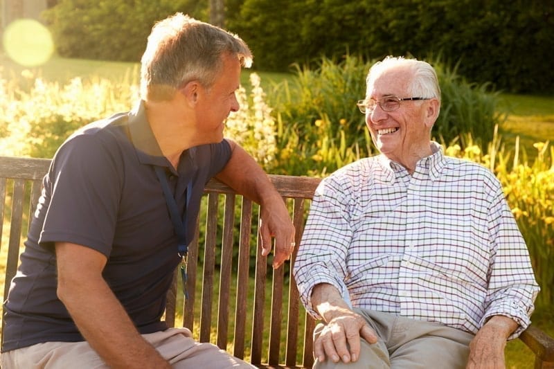 Man Visiting Senior Male Relative In Assisted Living Facility
