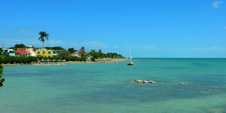 A beautiful warm water beach in Corozal, Belize with bright blue skies.
