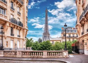 Small Paris street with view on the famous Eiffel Tower in Paris, France.