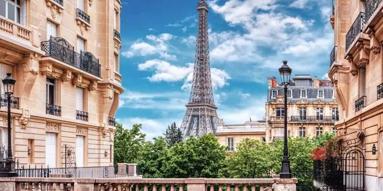 Small Paris street with view on the famous Eiffel Tower in Paris, France.