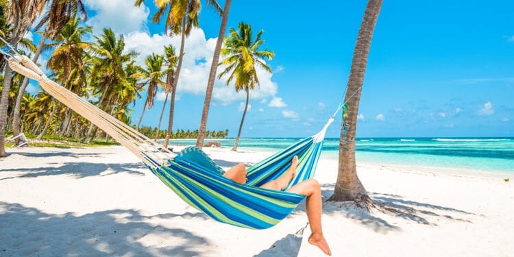 Woman relaxing on a hammock in Saona Island, Dominican Republic