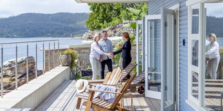 Real estate agent showing property to senior couple