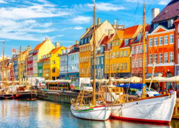 Famous old Nyhavn port in the center of Copenhagen, Denmark during summer sunny day