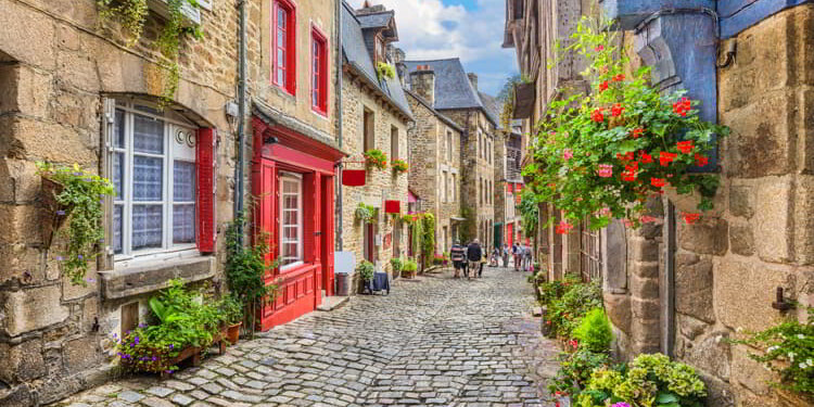 Idyllic scene of traditional houses in narrow alley in an old town in Europe
