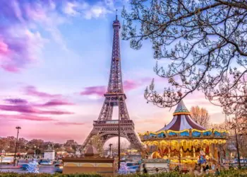 The Eiffel Tower and vintage carousel on a winter evening in Paris, France