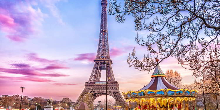 The Eiffel Tower and vintage carousel on a winter evening in Paris, France