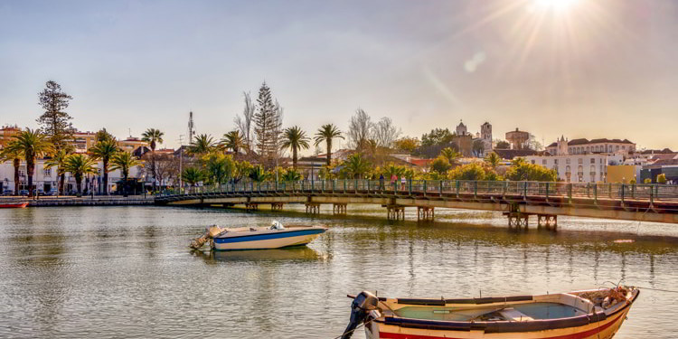 Colorful boats on Gilao river in picturesque Tavira, Portugal