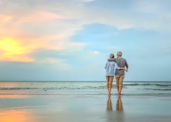 Senior couple walking on the beach. Are You Ready To “Retire Up”? wealthy