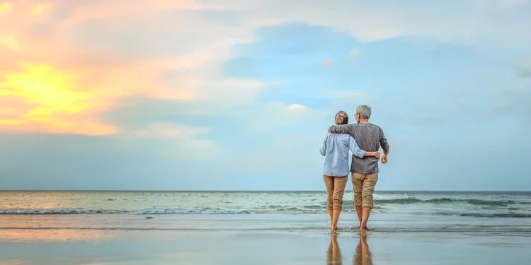 Senior couple walking on the beach. Are You Ready To “Retire Up”? wealthy