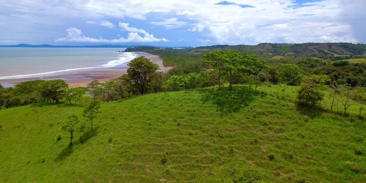 Green meadow with amazing view of tropical beach by the Pacific Ocean. life in Panama