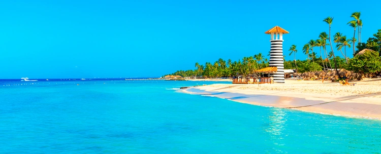 Panoramic view of the tropical beach with lighthouse in Dominican Republic. cost of living