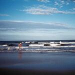 A man runs along an Argentina beach