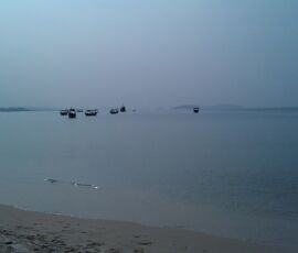 Fishing boats bob in the ocean, Cambodia.