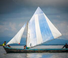 A local family sail a traditional boat around the San Blas Islands, Panama.