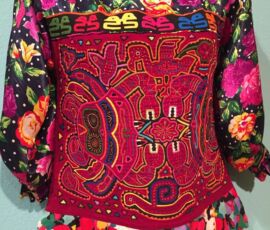This Oct 1, 2015 photo shows an example of mola, a sewing tradition of the Kona tribe from the San Blas islands of Panama, on display at the Tucson Museum of Art in Arizona. Mola involves cutting and stitching layers of colored fabric using applique techniques. This display is part of an exhibition called "La Vida Fantastica." (AP Photos/Beth J. Harpaz) Crafts-Mola